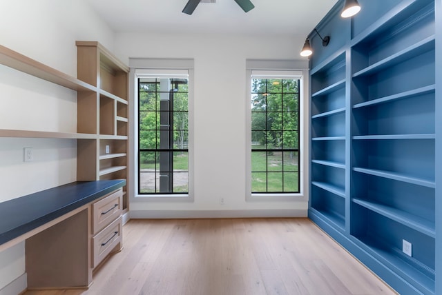 15086 Dewberry Ln, Conroe, TX 77302 - unfurnished office with built in study area, light wood-style flooring, healthy amount of natural light, and a ceiling fan