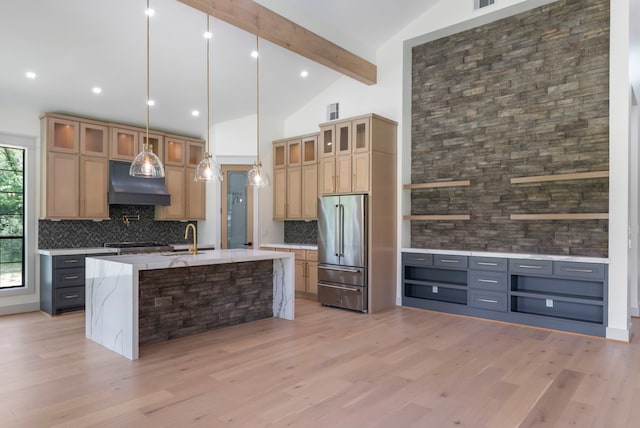 15086 Dewberry Ln, Conroe, TX 77302 - kitchen with high quality fridge, custom exhaust hood, decorative backsplash, light wood-style floors, and beam ceiling