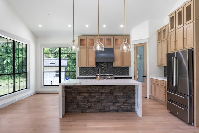 15086 Dewberry Ln, Conroe, TX 77302 - kitchen with high end fridge, tasteful backsplash, a sink, light wood-style floors, and recessed lighting