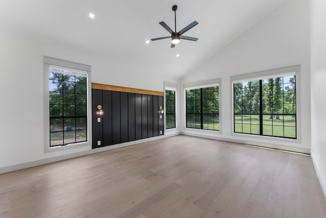 15086 Dewberry Ln, Conroe, TX 77302 - unfurnished room with plenty of natural light, high vaulted ceiling, wood finished floors, a ceiling fan, and recessed lighting