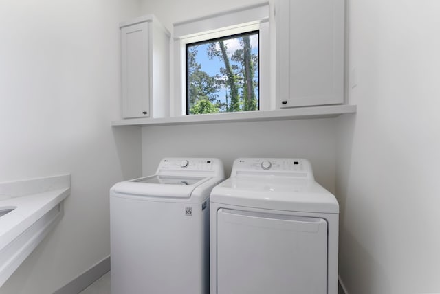 15086 Dewberry Ln, Conroe, TX 77302 - laundry area featuring washing machine and clothes dryer and cabinet space