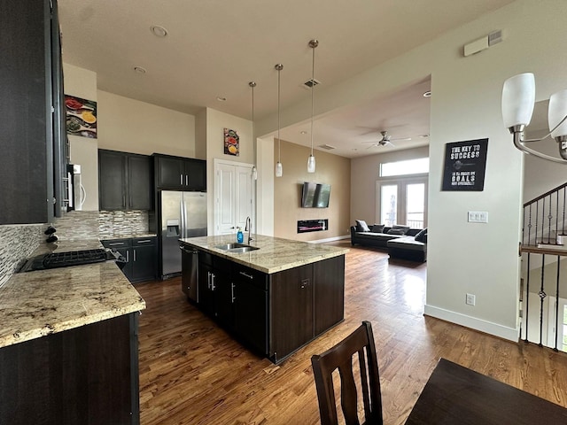 1613 Bonner St, Houston, TX 77007 - kitchen with stainless steel appliances, dark wood-style flooring, a ceiling fan, a sink, and tasteful backsplash