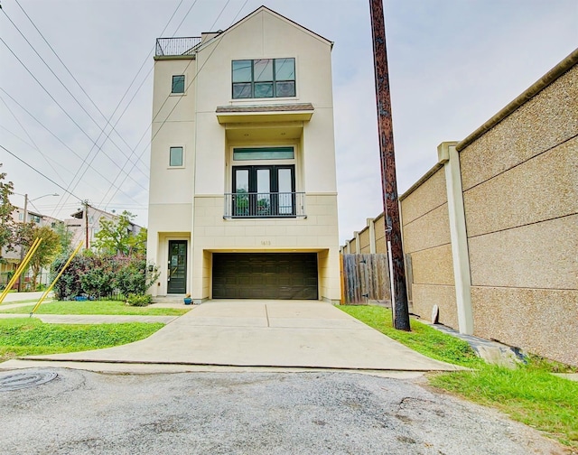 1613 Bonner St, Houston, TX 77007 - view of front of house with a balcony, an attached garage, concrete driveway, and stucco siding