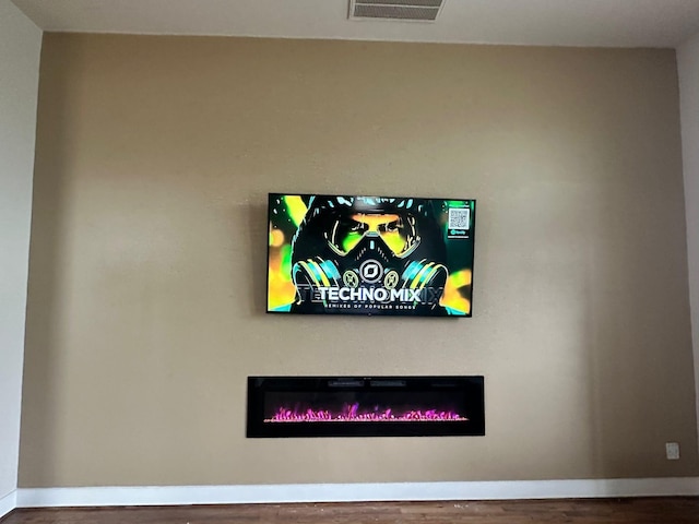 1613 Bonner St, Houston, TX 77007 - detailed view of wood finished floors, a glass covered fireplace, and baseboards