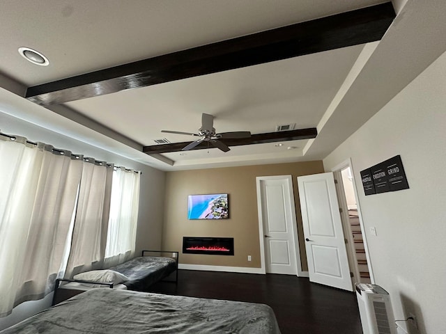 1613 Bonner St, Houston, TX 77007 - bedroom featuring baseboards, dark wood-style floors, beamed ceiling, a glass covered fireplace, and a tray ceiling