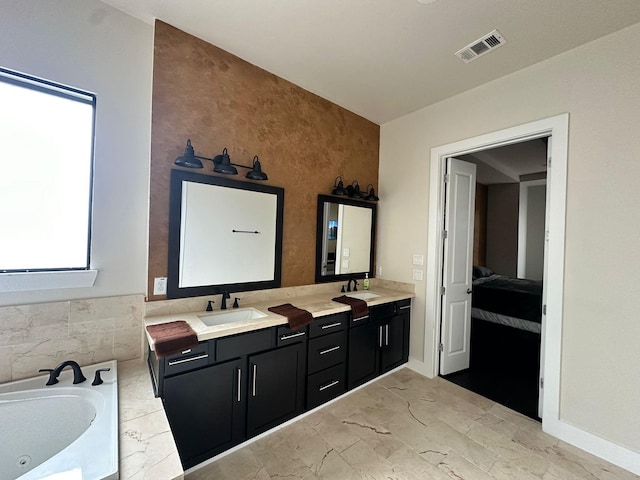 1613 Bonner St, Houston, TX 77007 - bathroom featuring double vanity, a tub with jets, marble finish flooring, ensuite bathroom, and tile walls