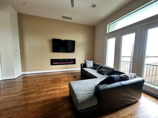 1613 Bonner St, Houston, TX 77007 - living area with wood finished floors, a glass covered fireplace, baseboards, ceiling fan, and recessed lighting