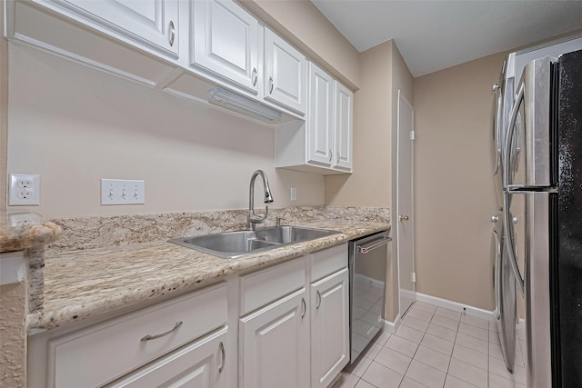 2110 Wilcrest Dr Unit 236, Houston, TX 77042 - kitchen featuring appliances with stainless steel finishes, a sink, light tile patterned flooring, white cabinets, and light countertops