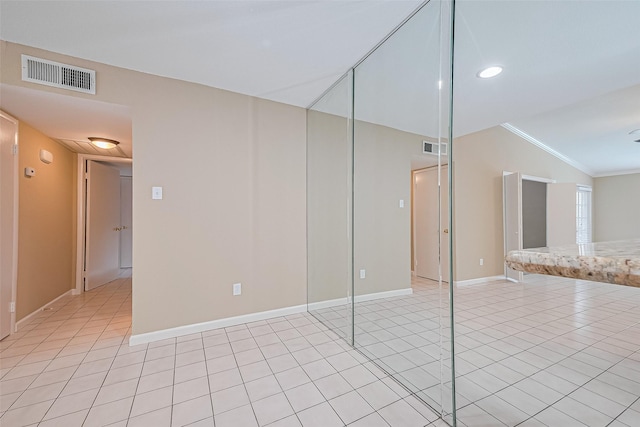 2110 Wilcrest Dr Unit 236, Houston, TX 77042 - spare room with vaulted ceiling, crown molding, light tile patterned flooring, and baseboards