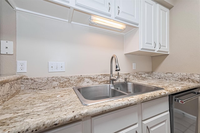 2110 Wilcrest Dr Unit 236, Houston, TX 77042 - kitchen featuring a sink, stainless steel dishwasher, and white cabinetry