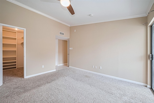 2110 Wilcrest Dr Unit 236, Houston, TX 77042 - unfurnished bedroom featuring carpet flooring, ornamental molding, a spacious closet, baseboards, and a ceiling fan