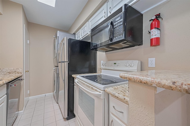 2110 Wilcrest Dr Unit 236, Houston, TX 77042 - kitchen with electric stove, black microwave, stainless steel dishwasher, light tile patterned floors, and white cabinets