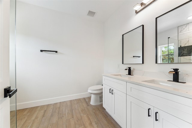 3700 Avenue S, Santa Fe, TX 77510 - full bathroom with toilet, double vanity, wood finished floors, a shower, and baseboards