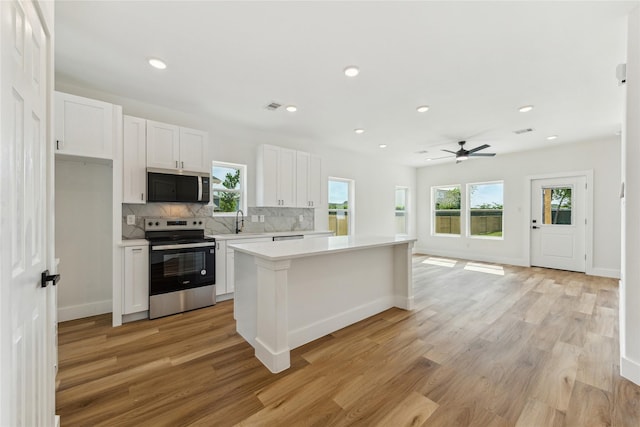 3700 Avenue S, Santa Fe, TX 77510 - kitchen with stainless steel appliances, light countertops, healthy amount of natural light, tasteful backsplash, and recessed lighting