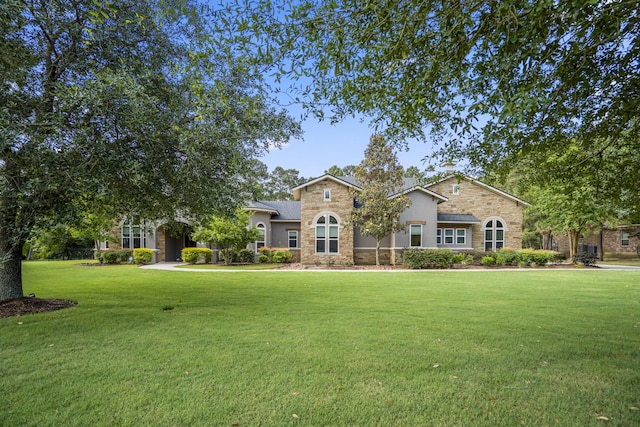 12911 Mossy Shr, Tomball, TX 77375 - view of front of property featuring stone siding, a front lawn, and stucco siding