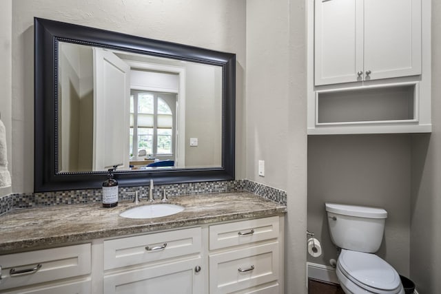 12911 Mossy Shr, Tomball, TX 77375 - bathroom featuring toilet, vanity, and baseboards