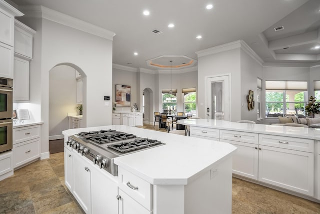 12911 Mossy Shr, Tomball, TX 77375 - kitchen with arched walkways, appliances with stainless steel finishes, ornamental molding, recessed lighting, and a center island