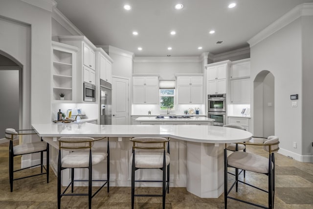 12911 Mossy Shr, Tomball, TX 77375 - kitchen with arched walkways, built in appliances, a peninsula, crown molding, and open shelves