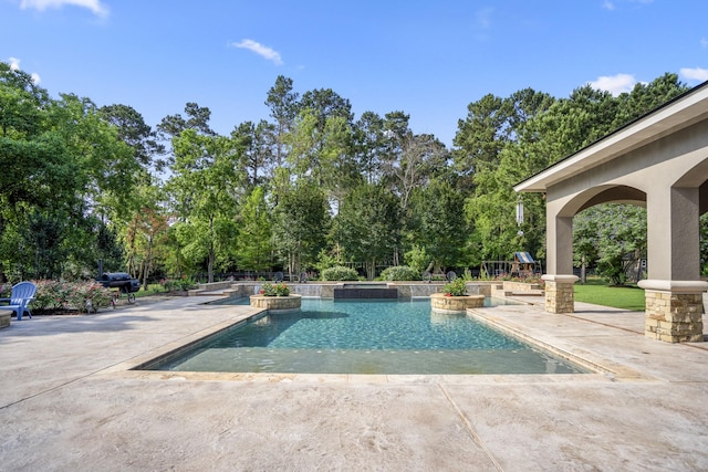 12911 Mossy Shr, Tomball, TX 77375 - view of pool with a patio area, view of scattered trees, and a pool with connected hot tub