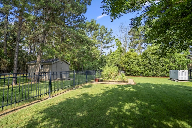 12911 Mossy Shr, Tomball, TX 77375 - view of yard featuring a garden, an outdoor structure, a garage, and view of scattered trees