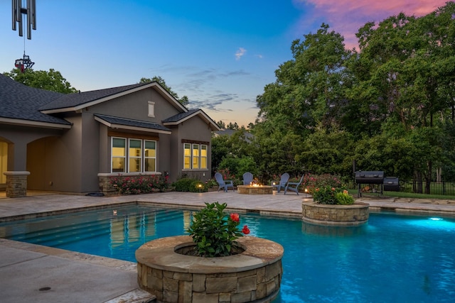 12911 Mossy Shr, Tomball, TX 77375 - pool at dusk with an outdoor fire pit, a patio area, an outdoor pool, and area for grilling