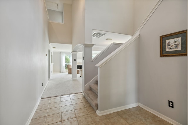 19710 Ringwald Ct, Spring, TX 77379 - stairs featuring a high ceiling, baseboards, carpet, and tile patterned floors
