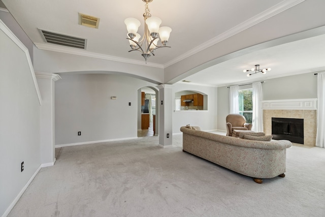 19710 Ringwald Ct, Spring, TX 77379 - carpeted living room with arched walkways, a chandelier, baseboards, ornamental molding, and a fireplace