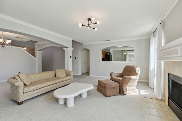 19710 Ringwald Ct, Spring, TX 77379 - living area with a chandelier, arched walkways, light colored carpet, a tiled fireplace, and ornamental molding