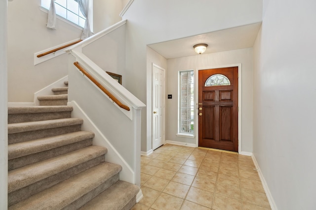 19710 Ringwald Ct, Spring, TX 77379 - entryway with stairway, healthy amount of natural light, light tile patterned floors, and baseboards