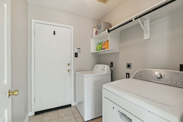19710 Ringwald Ct, Spring, TX 77379 - washroom featuring washing machine and clothes dryer, light tile patterned floors, and baseboards