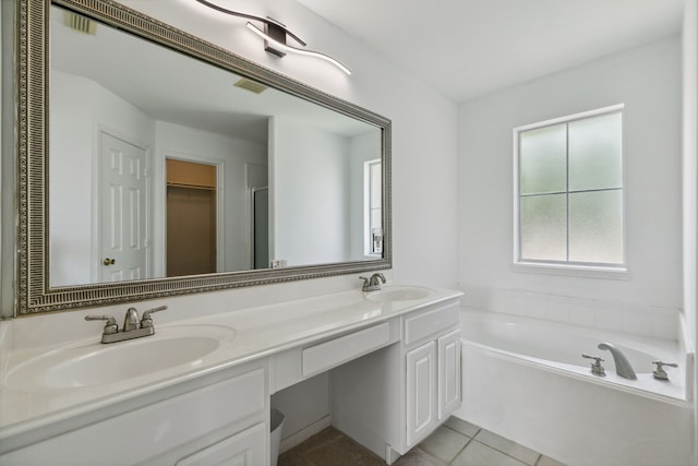 19710 Ringwald Ct, Spring, TX 77379 - bathroom featuring double vanity, a garden tub, tile patterned floors, and a walk in closet