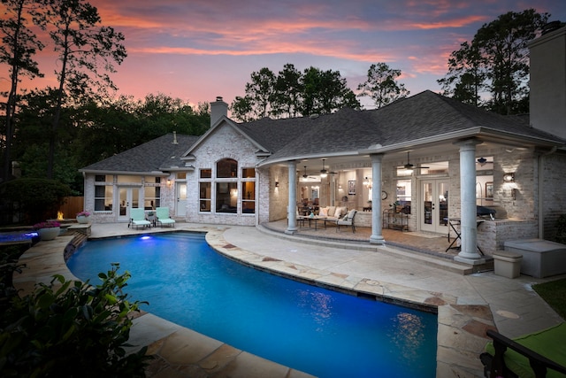63 N Wooded Brook Cir, The Woodlands, TX 77382 - outdoor pool featuring french doors, a ceiling fan, an outdoor hangout area, and a patio area