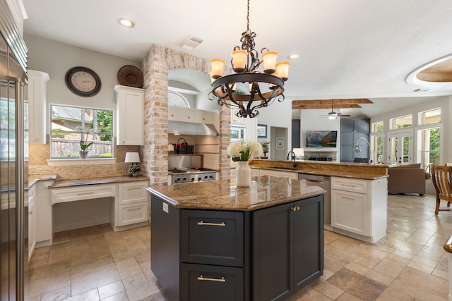 63 N Wooded Brook Cir, The Woodlands, TX 77382 - kitchen featuring open floor plan, appliances with stainless steel finishes, plenty of natural light, stone tile floors, and recessed lighting
