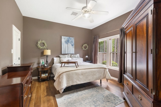 63 N Wooded Brook Cir, The Woodlands, TX 77382 - bedroom featuring dark wood-style flooring, baseboards, and ceiling fan
