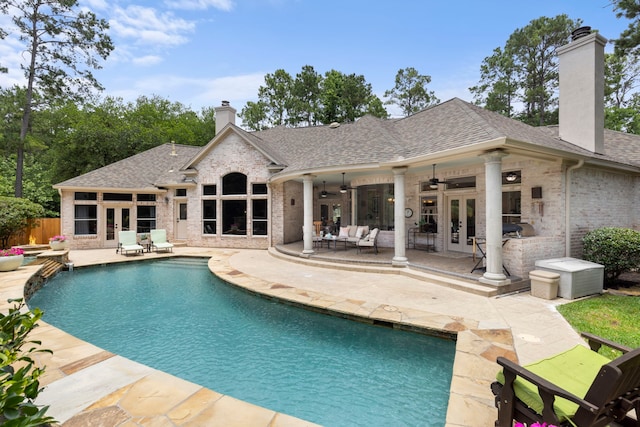 63 N Wooded Brook Cir, The Woodlands, TX 77382 - view of swimming pool featuring french doors, a ceiling fan, a patio, and outdoor lounge area