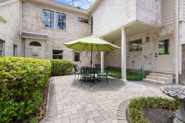 63 N Wooded Brook Cir, The Woodlands, TX 77382 - view of patio featuring entry steps and outdoor dining area