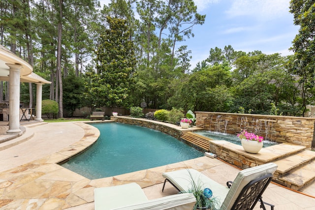63 N Wooded Brook Cir, The Woodlands, TX 77382 - view of pool with a patio, a fenced backyard, a pool with connected hot tub, and view of scattered trees