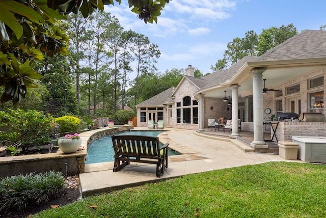 63 N Wooded Brook Cir, The Woodlands, TX 77382 - outdoor pool with a ceiling fan, an outdoor kitchen, a patio area, and a lawn
