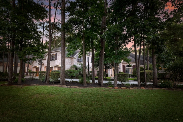 63 N Wooded Brook Cir, The Woodlands, TX 77382 - yard at dusk with a lawn