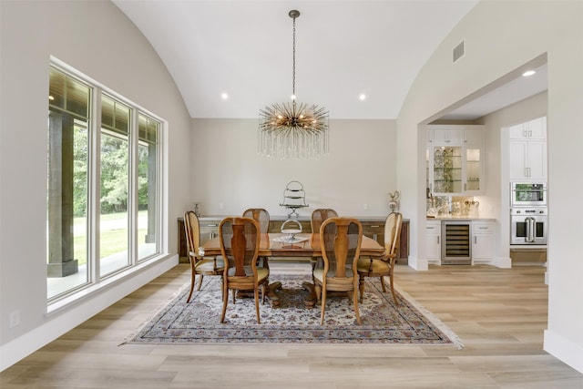 18 N Smith Loop N, Cleveland, TX 77327 - dining room featuring beverage cooler, vaulted ceiling, wet bar, light wood-style floors, and a chandelier