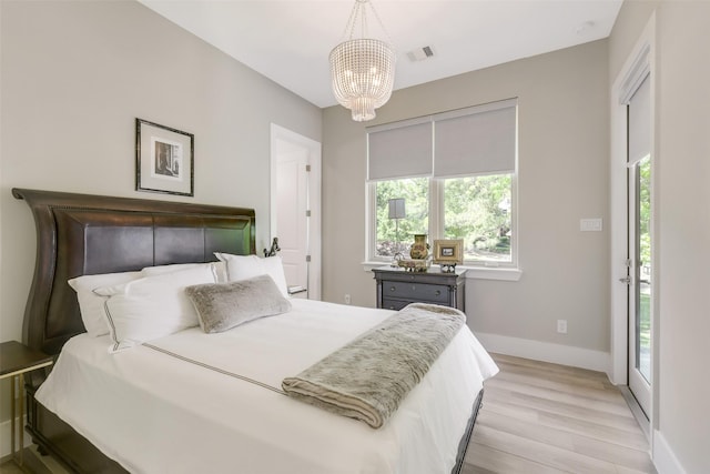 18 N Smith Loop N, Cleveland, TX 77327 - bedroom with light wood-type flooring, a chandelier, baseboards, and access to exterior