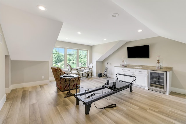 18 N Smith Loop N, Cleveland, TX 77327 - living room featuring wine cooler, a dry bar, light wood-style flooring, baseboards, and vaulted ceiling
