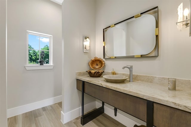 18 N Smith Loop N, Cleveland, TX 77327 - bathroom featuring vanity, baseboards, and wood finished floors