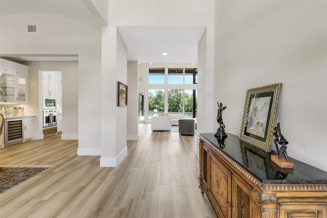 18 N Smith Loop N, Cleveland, TX 77327 - corridor featuring beverage cooler, light wood-style floors, baseboards, and recessed lighting