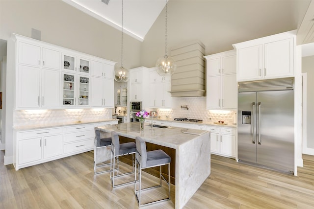 18 N Smith Loop N, Cleveland, TX 77327 - kitchen with stainless steel appliances, custom exhaust hood, decorative backsplash, a sink, and white cabinets