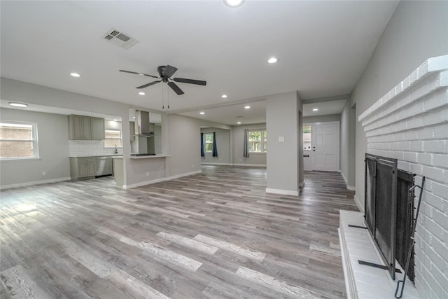 5915 Valkeith Dr, Houston, TX 77096 - unfurnished living room featuring a fireplace, recessed lighting, a ceiling fan, light wood-type flooring, and baseboards