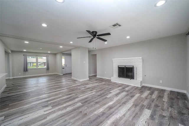 5915 Valkeith Dr, Houston, TX 77096 - unfurnished living room with recessed lighting, wood finished floors, ceiling fan, a brick fireplace, and baseboards