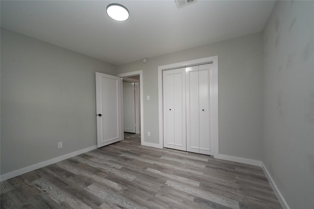 5915 Valkeith Dr, Houston, TX 77096 - unfurnished bedroom featuring wood finished floors, baseboards, and a closet