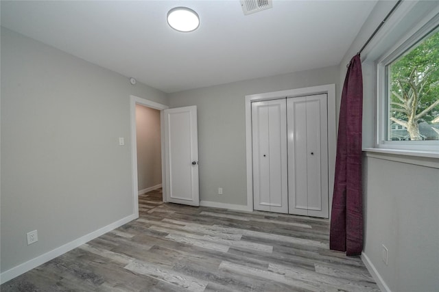 5915 Valkeith Dr, Houston, TX 77096 - unfurnished bedroom featuring wood finished floors, baseboards, and a closet