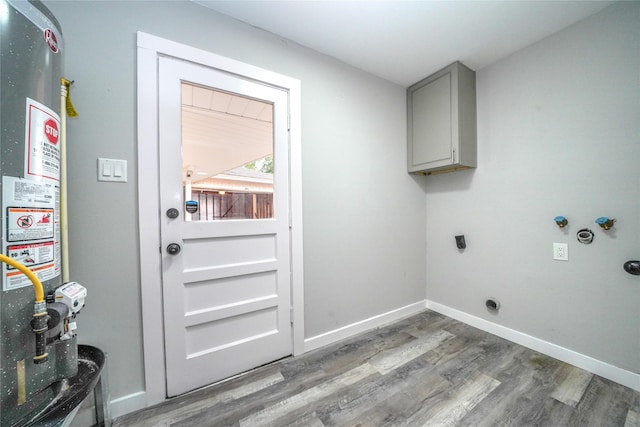 5915 Valkeith Dr, Houston, TX 77096 - laundry area featuring electric dryer hookup, water heater, wood finished floors, and cabinet space